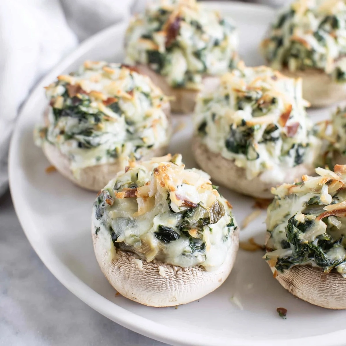 Golden-brown Creamy Spinach and Artichoke Stuffed Mushrooms ready to serve, a delicious appetizer.