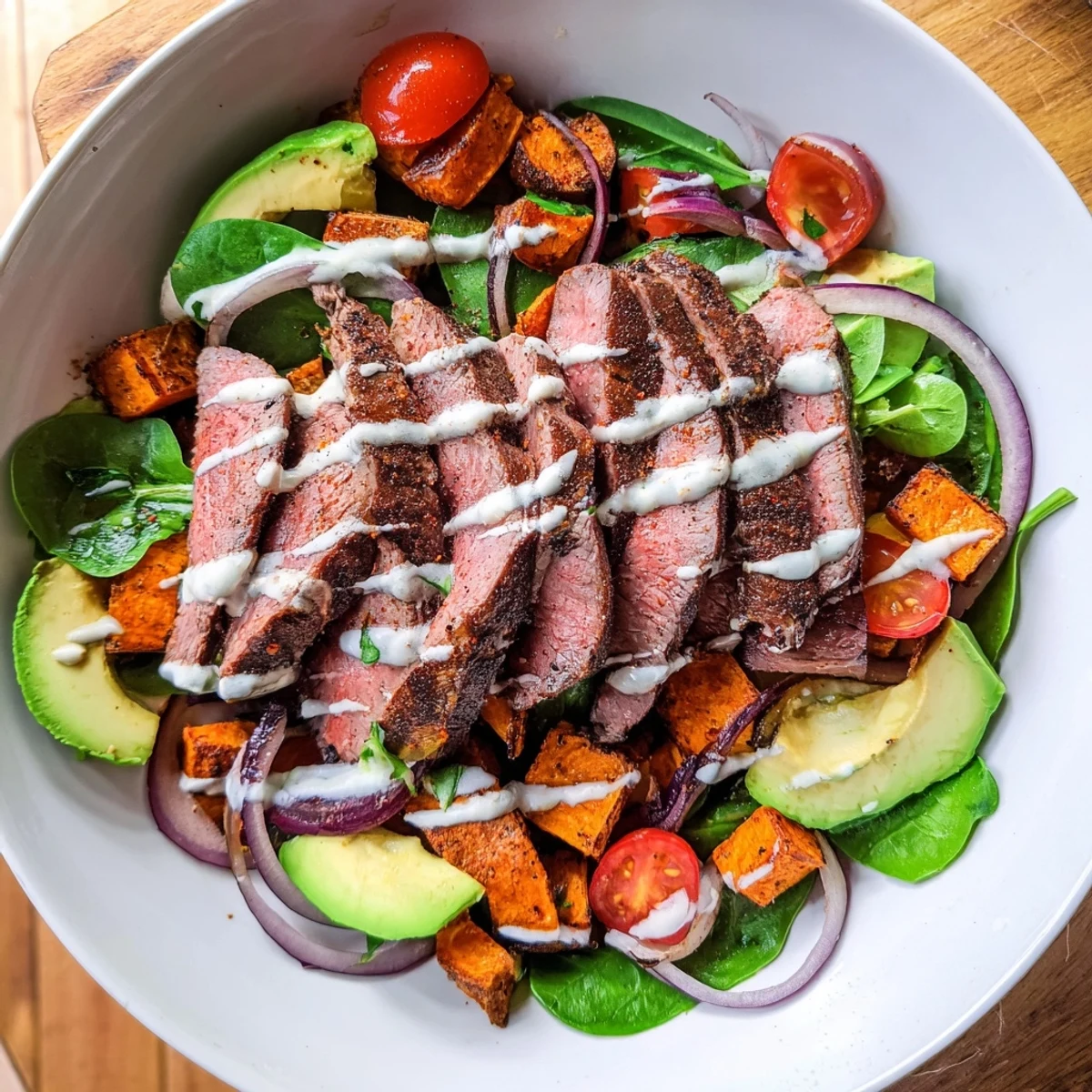 Golden-roasted sweet potatoes and seared beef make up this vibrant Beef Avocado Sweet Potato Bowl.