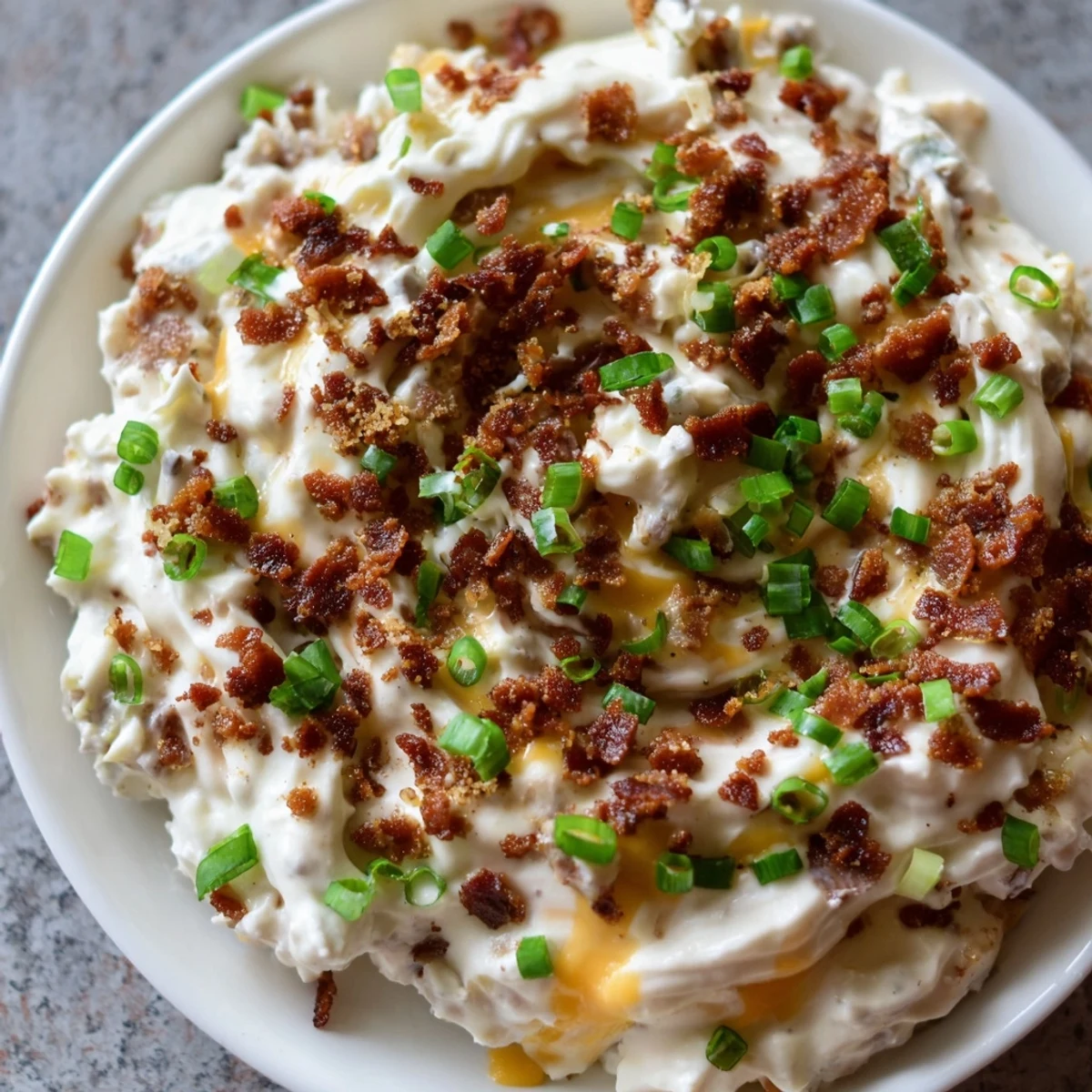 Warm, creamy cheesy bacon ranch dip, perfect for parties; a flavorful appetizer with vibrant aromas.