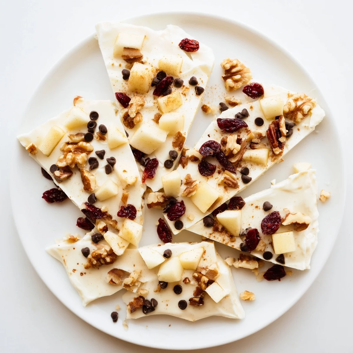 Frozen apple cinnamon yogurt bark, a refreshing treat with sweet apple chunks and crunchy nuts.