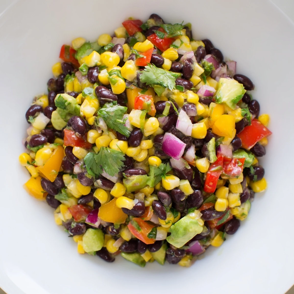 Vibrant close-up of Southwest Black Bean Salad, full of corn and peppers, ready to eat.