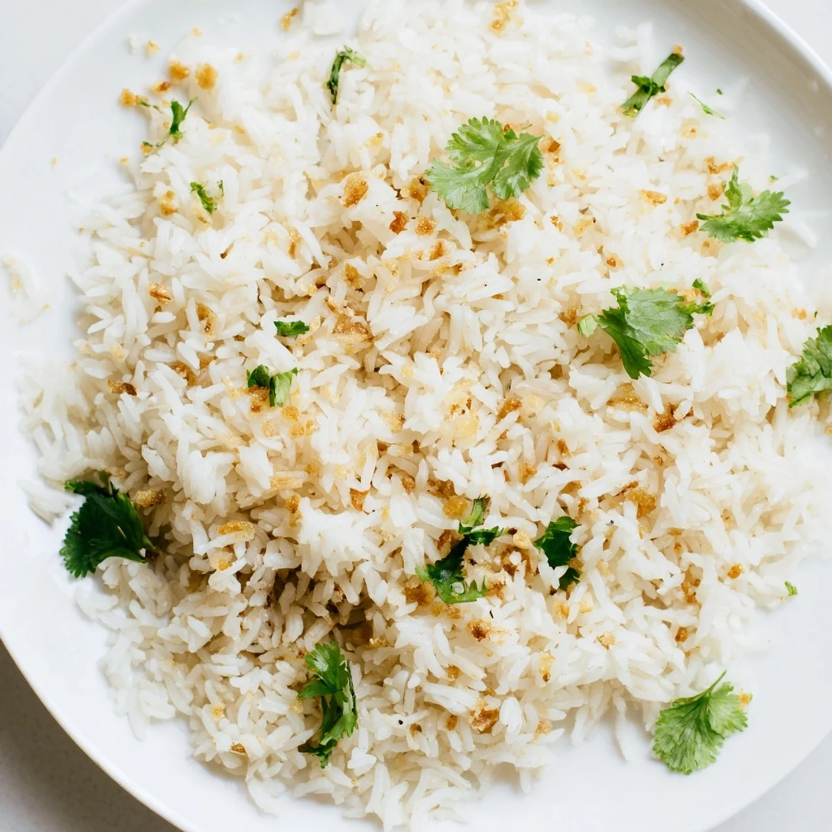 Serving suggestion of jasmine rice garlic side dish with tender grains and a savory, fragrant aroma.