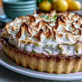 Homemade Lemon Meringue Pie cooling on a wire rack, showing a tangy lemon filling and crisp crust.