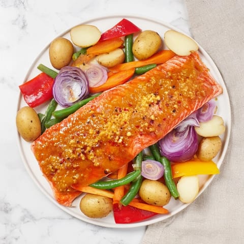 Golden-brown One-Tray Baked Salmon with vibrant roasted vegetables and glossy honey mustard.