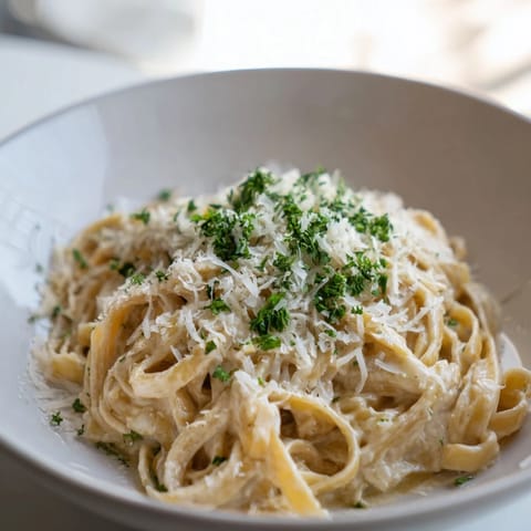 Golden, creamy Alfredo pasta with parsley garnish, perfect for a quick and satisfying Italian dinner tonight.