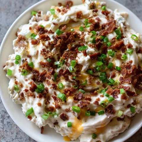 Warm, creamy cheesy bacon ranch dip, perfect for parties; a flavorful appetizer with vibrant aromas.