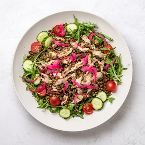 Hearty Lentil & Chicken Spring Salad tossed in zesty mustard dressing, featuring juicy chicken, lentils, and crisp arugula.