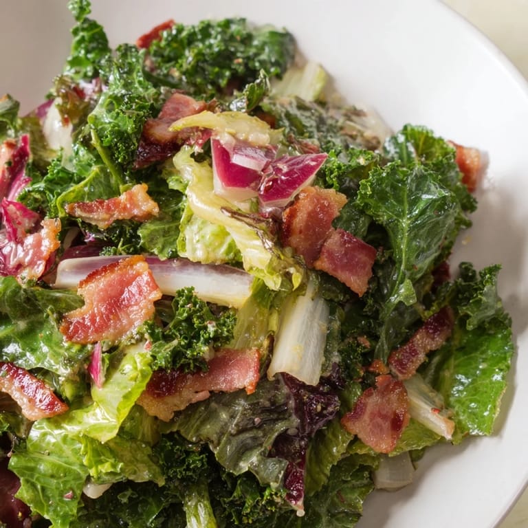 Tossed Bitter Greens Salad with Warm Bacon Dressing is bursting with flavor, perfect for a starter.
