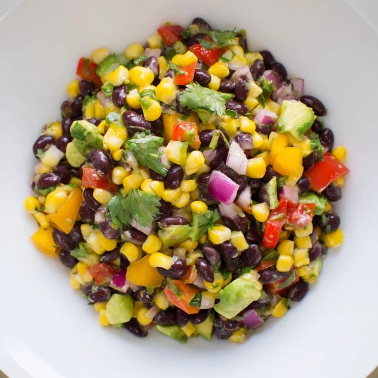 Vibrant close-up of Southwest Black Bean Salad, full of corn and peppers, ready to eat.