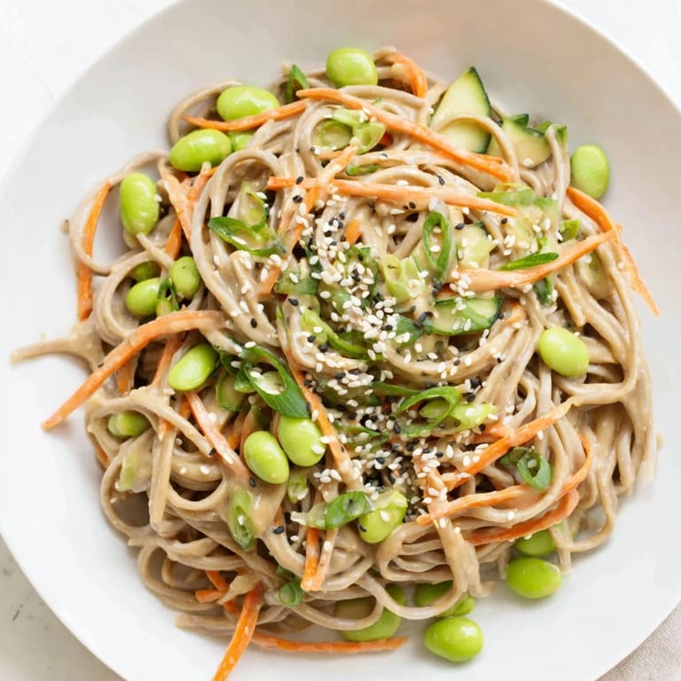 Freshly tossed Asian Sesame Noodle Salad, served with optional garnishes, perfect for a light vegetarian lunch.