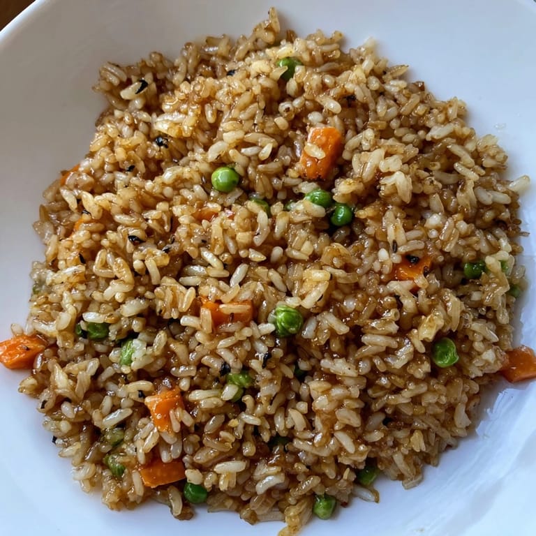 Topped with sesame seeds and green onions, this easy Black Garlic Fried Rice is served ready for a family meal.