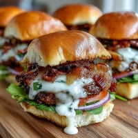 Juicy Easy Father's Day Grilled Bacon Burger Sliders with melted cheese.